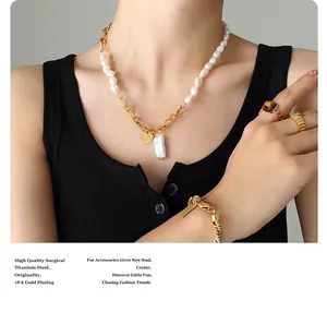 Close-up of heart charm necklace with Baroque pearls and 18K gold plated titanium chain