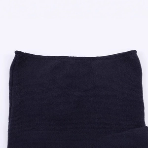 Close-up of black knitted knot top with premium fabric texture on white background