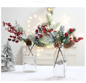 Close-up of artificial cedar branches with red berries and pine cones in glass vases