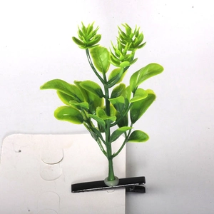 Macro shot of green bean sprout hair clips with black metal duckbill clips on card