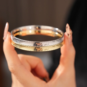 Detailed view of honeycomb texture and metallic finish on these layered bangles