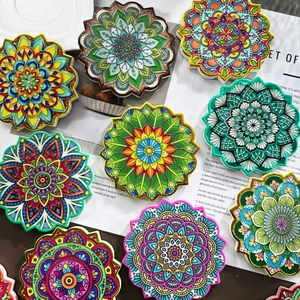 Detail of colorful octagonal mandala ceramic coasters with gold foil vintage patterns
