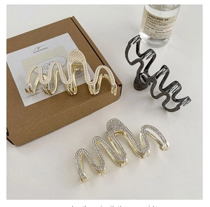 Macro detail of wave-shaped hair clips with pearl and rhinestone inlay craftsmanship