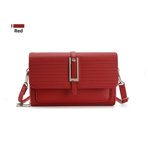 Close-up of red crossbody bag featuring woven texture and silver metal buckle detail