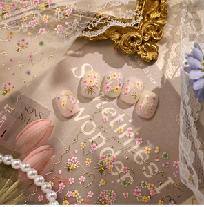 Close-up of TL-45 floral nail stickers with 3D embossed gold lines and purple flowers
