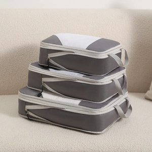 Three-piece grey compression packing cubes made of ripstop nylon with breathable mesh top