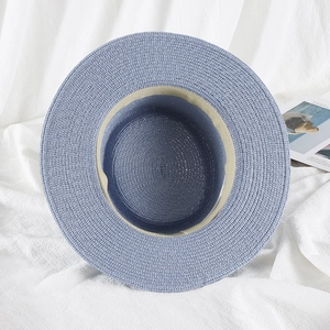 Top view of blue woven straw sun hat showing interior sweatband and fine texture