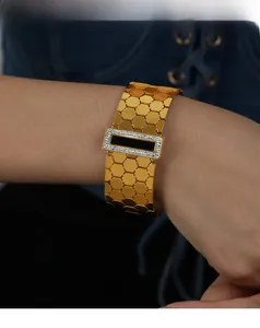 Close-up of a gold hexagonal honeycomb bangle featuring a black rectangle and zircon pavé