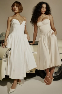 Close-up of French vintage sundresses with structured satin fabric and corseted waist