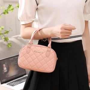 Pink quilted crossbody handbag for women in a stylish professional setting
