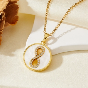 Gold stainless steel necklace featuring a circular infinity shell pendant with tiny zircons
