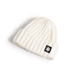 Detailed view of white ribbed knit beanie featuring a snowflake patch and soft texture