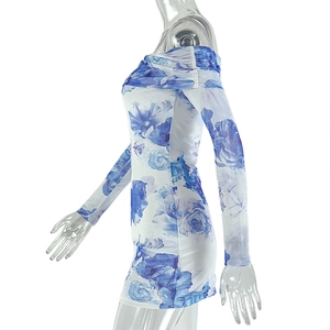 Detail of off-shoulder mini dress with blue floral print and elastic fabric on side view