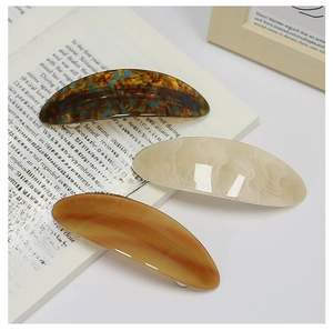 Detail of tortoise shell and cream acetate hair clips with French vintage textures