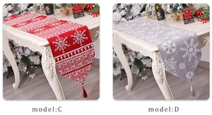 Detail of Christmas jacquard table runners in red and grey with snowflake patterns