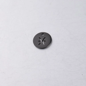 Macro shot of 12mm black mirror-finish stainless steel Pisces zodiac pendant with cutout