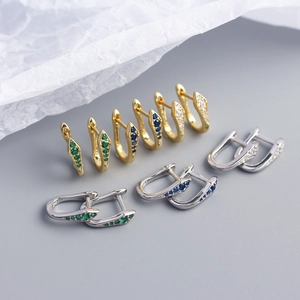 Detail of S925 sterling silver U-shaped hoop earrings with colorful zircon snake design