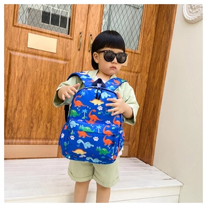 Detail of blue toddler dinosaur backpack featuring digital prints and durable zippers