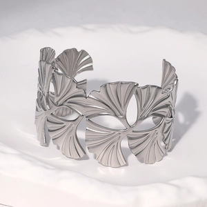 Adjustable stainless steel open cuff bracelet with intricate ginkgo leaf pattern engraving