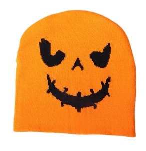 Close-up of bright orange knitted beanie featuring a black Halloween pumpkin face pattern