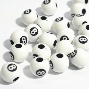 Macro shot of white acrylic beads with black number 8 print and holes for DIY crafts