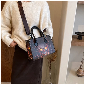 Detail of skull print tote bag with lava pattern and branded nylon shoulder strap