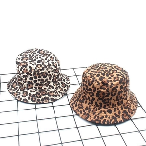 Detailed top view of leopard print suede bucket hats in beige and brown tones