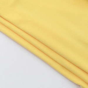 Detail view of the high-quality yellow knitted fabric texture on the slim fit tube top