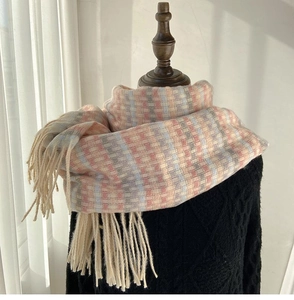 Close-up of pastel rainbow checkered scarf with thick fringe on a black sweater