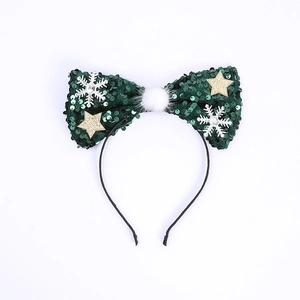 Detail of green sequin Christmas headband with white snowflake and gold star accents
