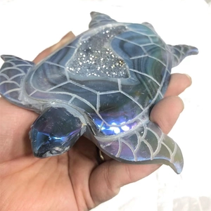 Detail of hand-held turtle keychain featuring natural blue agate and sparkling crystal druzy