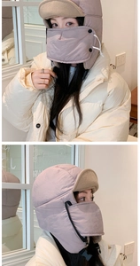 Detail of pink winter earflap hat with detachable mask and warm fleece lining