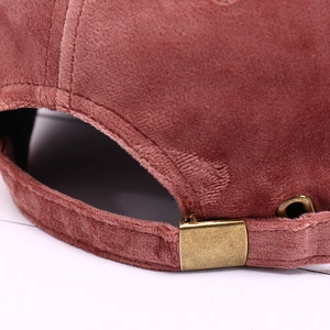 Pink velvet baseball cap with adjustable bronze metal buckle and premium fabric texture