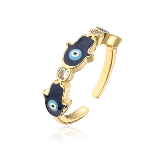 Detail of 18K gold plated Hamsa Hand and Evil Eye ring with blue enamel and zircons