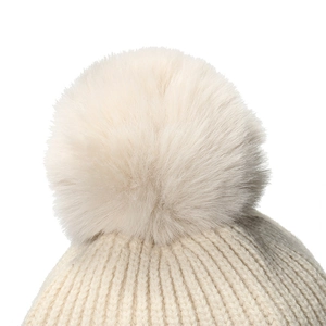 Detailed macro view of an off-white knitted baby hat with a fluffy faux fur pom-pom