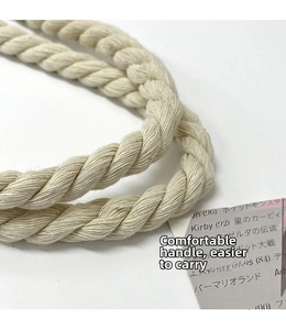 Detail of multi-strand braided cotton rope handle on ethnic canvas tote bag