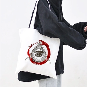 Detailed shot of white canvas tote bag with red and black Demon Eye and Ouroboros print