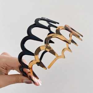 Detail view of wavy hairbands in classic black and amber tortoiseshell patterns