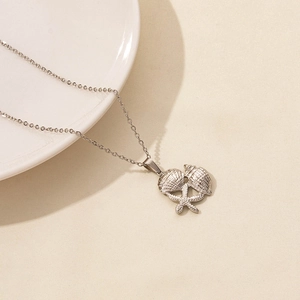 Detail of silver starfish and seashell pendants on a delicate link chain necklace
