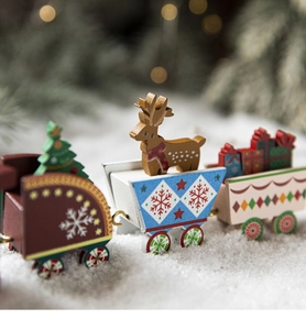 Close-up of painted wooden Christmas train with reindeer and gift box figurines