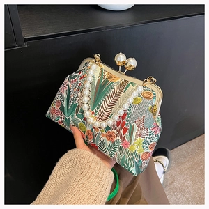 Detail der Vintage-Blumenhandtasche mit Perlen Griff und goldenem Perlenverschluss