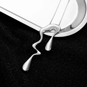 Detail view of silver liquid lava pendant necklace with minimalist metal chain