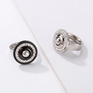Macro view of stainless steel rings with zircon inlay in black and silver finishes
