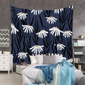 Detail of bohemian daisy tapestry with dark blue background hung on a grey bedroom wall