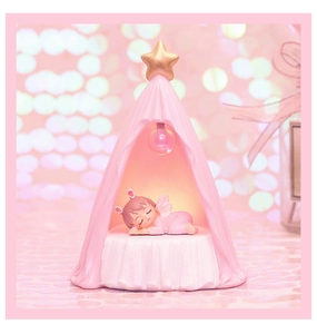 Close-up of pink tent night light featuring a sleeping angel figure and golden star decoration