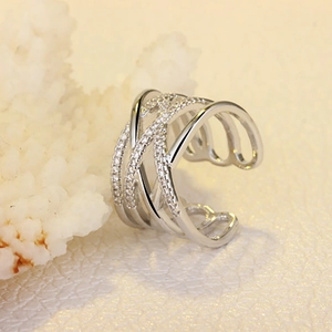 Close-up of silver double-layer ring with sparkling zircon insets on textured coral base