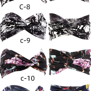 Detail of four colorful bohemian knot headbands with floral prints on white background