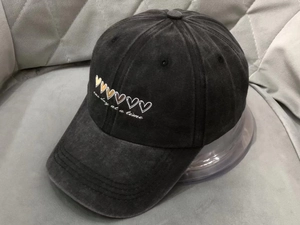 Detail of vintage washed cotton baseball cap with embroidered One Day At A Time text