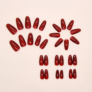 Detail of almond-shaped cat-eye press-on nails in deep red color showing 24 pieces