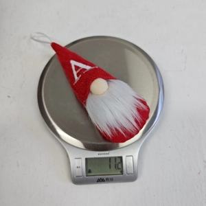Detail view of a red knitted Christmas gnome ornament with embroidered letter A weighing 11.2g